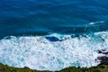 Aerial view of a giant ocean wave crushing onto the shore. Top down photo of turquoise sea water surface. White foam Royalty Free Stock Photo