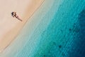 Aerial view of a girl on the beach on Bali, Indonesia. Vacation and adventure. Beach and turquoise water. Top view from drone at b Royalty Free Stock Photo