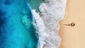 Aerial view of a girl on the beach. Beach and turquoise water. Top view from drone at beach, azure sea and relax girl.