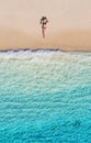 Aerial view of a girl on the beach. Vacation and adventure. Beach and turquoise water. Top view from drone at beach, azure sea and Royalty Free Stock Photo