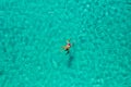 Aerial view of a girl floating in the turquoise sea of the Sakarun beach, Adriatic Sea