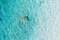 Aerial view of a girl on ocean on Bali, Indonesia. Vacation and adventure. Turquoise water. Top view from drone at ocean, azure wa Royalty Free Stock Photo