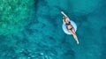 Aerial view at the girl on sea. Turquoise water from air as a background from air.