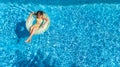 Aerial view of girl in swimming pool from above, kid swim on inflatable ring donut in water on family vacation Royalty Free Stock Photo