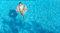 Aerial view of girl in swimming pool from above, kid swim on inflatable ring donut in water on family vacation Royalty Free Stock Photo