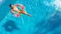 Aerial view of girl in swimming pool from above, kid swim on inflatable ring donut in water on family vacation Royalty Free Stock Photo