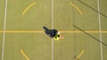 Aerial view of a girl who scores goals in a 5-a-side football pitch