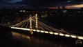 Aerial view of a glowing illuminated bridge at night in London, United Kingdom