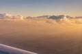 Aerial view of golden clouds lit by the evening sun over Florida, view from the aircraft during the flight. Royalty Free Stock Photo