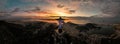 Aerial view of a golden sunset illuminating the statue of Jesus Christ in Rio de Janeiro, Brazil.