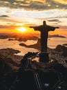 Aerial view of a golden sunset illuminating the statue of Jesus Christ in Rio de Janeiro, Brazil.