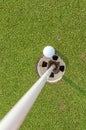 Aerial view of golf ball near pin and hole on green grass of golf course Royalty Free Stock Photo