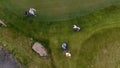 Aerial view Golf course. Golfers walking down the fairway on a course with golf bag and trolley Royalty Free Stock Photo