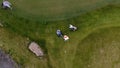 Aerial view Golf course. Golfers walking down the fairway on a course with golf bag and trolley Royalty Free Stock Photo