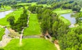 Aerial view of a golf course with trees, ponds, and winding paths Royalty Free Stock Photo