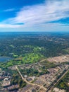 Aerial view of golf courses in a densely forested urban development