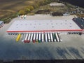 Aerial view of goods warehouse. Logistics center in industrial city zone from above.