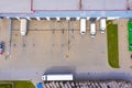 Aerial view of goods warehouse. Logistics center in industrial city zone from above. Aerial view of trucks loading at logistic Royalty Free Stock Photo