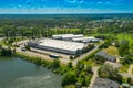 Aerial view of goods warehouse. Logistics center in industrial city zone from above. Aerial view of trucks loading at logistic