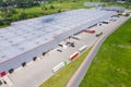 Aerial view of goods warehouse. Logistics center in industrial city zone from above. Aerial view of trucks loading at logistic Royalty Free Stock Photo