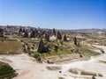 Aerial view of Goreme National Park, Tarihi Milli Parki, Turkey. The typical rock formations of Cappadocia. Tourists on quads Royalty Free Stock Photo