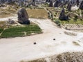 Aerial view of Goreme National Park, Tarihi Milli Parki, Turkey. The typical rock formations of Cappadocia. Tourists on quads Royalty Free Stock Photo