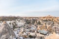 Aerial view of Goreme town with cave hotel built in rock formation in national park Goreme under the golden sunlight in the