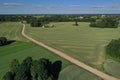 Aerial view of gravel road on farmland fields in summer Royalty Free Stock Photo