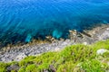 Aerial View of Greek Beach with Crean Turquoise Waters of Mediterranean Sea. Steep Rocks over the Beach in Greece. Royalty Free Stock Photo