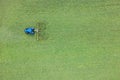 Aerial view of green field ,a tractor cutting the grass Royalty Free Stock Photo