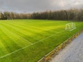 Aerial view on a green football pitch with trees shadows. Nobody. Sunny day Royalty Free Stock Photo