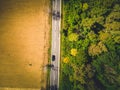 Aerial view of green forest asphalt road. Aerial view car truck drive going through forest. Royalty Free Stock Photo