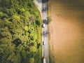 Aerial view of green forest asphalt road. Aerial view car truck drive going through forest. Royalty Free Stock Photo