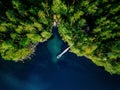 Aerial view of green forest, blue lake and wooden pier with boats in Finland Royalty Free Stock Photo