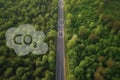 Aerial view green forest with car on the asphalt road. Air pollution from car exhaust on the road. Generative AI Royalty Free Stock Photo