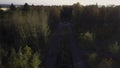 Aerial view of green forest and an empty road. Clip. Autumn natural background. Royalty Free Stock Photo