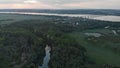 Aerial view of a green forest with a small river. Automobile bridge over the Dnieper river in the background Royalty Free Stock Photo