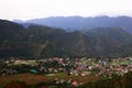 Aerial view of green hills of village in himachal surrounded by forest and countryside. Royalty Free Stock Photo