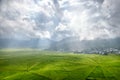 Aerial View of Green Lingko Spider Web Rice Fields with Sunlight Piercing Through Clouds to the Field with Raining. Flores, East N Royalty Free Stock Photo