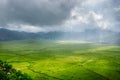 Aerial View of Green Lingko Spider Web Rice Fields with Sunlight Piercing Through Clouds to the Field with Raining. Flores, East N