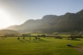 Aerial view of green meadows with villages and forest in austrian Alps mountains Royalty Free Stock Photo