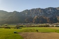 Aerial view of green meadows with villages and forest in austrian Alps mountains Royalty Free Stock Photo