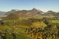 Aerial view of green meadows with villages and forest in austrian Alps mountains Royalty Free Stock Photo