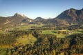 Aerial view of green meadows with villages and forest in austrian Alps mountains Royalty Free Stock Photo