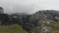 Aerial view of green mountains in rainy weather and dramatic cloudscape