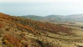 Aerial view of a green rural area under blue sky. Shot. Idyllic green valley natural scenery. Dramatic aerial view of