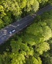 Aerial view of green summer forest with a road. Captured from above with a drone Royalty Free Stock Photo