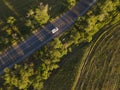 Aerial view of green summer forest with a road. Captured from above with a drone Royalty Free Stock Photo