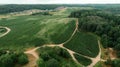 Aerial view of green summer forest and roads. Rural landscape.