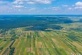 Aerial view on green and yellow parts of fields and countryside